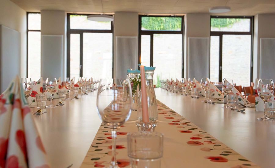 Blick auf eine festlich gedeckte Tafel mit Kerze und Weingläsern